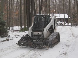 Brush hog equipment clearing thick overgrown vegetation from a field