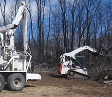 Active land clearing project removing trees and brush from a wooded lot
