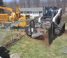 Stump grinder in action reducing a tree stump below grade level